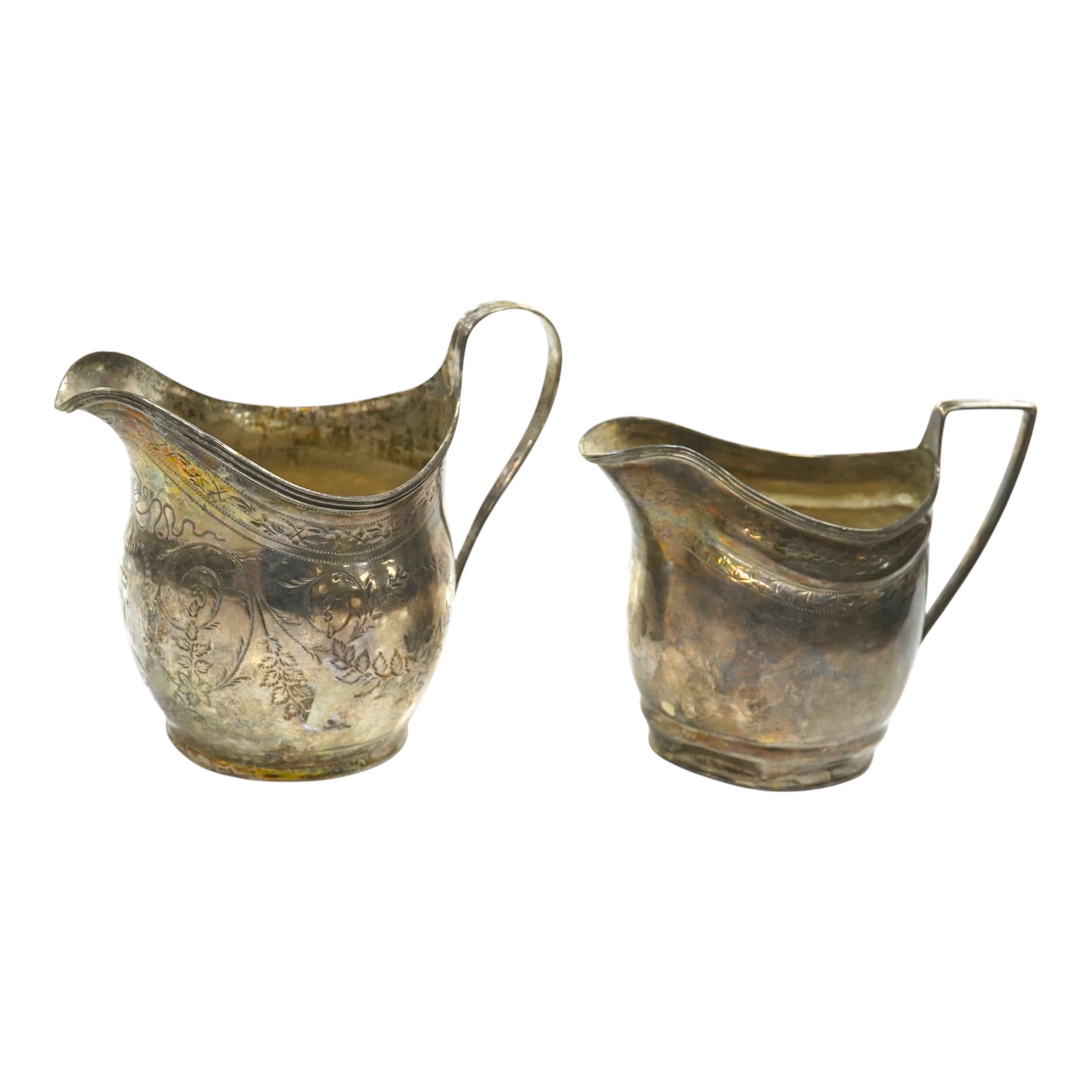 Two George III silver cream jugs, Sheffield, 1805 and London, 1808, largest 11cm. Condition - poor